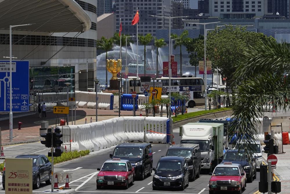 Water-filled barriers have been installed by police outside the Hong Kong Convention and Exhibition Centre where the inauguration ceremony of the newly-appointed Chief Executive John Lee will take place in Hong Kong, Monday, June 27, 2022. Questions continue to circle over whether Chinese leader Xi Jinping will attend the 25th year anniversary of Hong Kong's handover from British to Chinese rule and the inauguration of of the territory's new leader. (AP Photo/Kin Cheung)